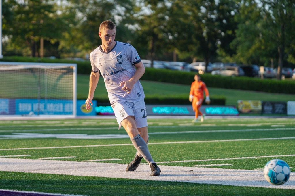 Nate Shultz passes the ball in the Greenville Triumph home match.