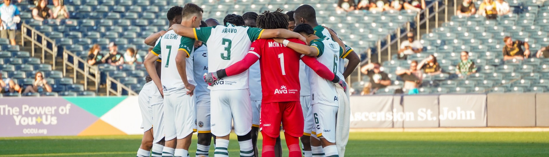 Oakland Roots SC team huddle.