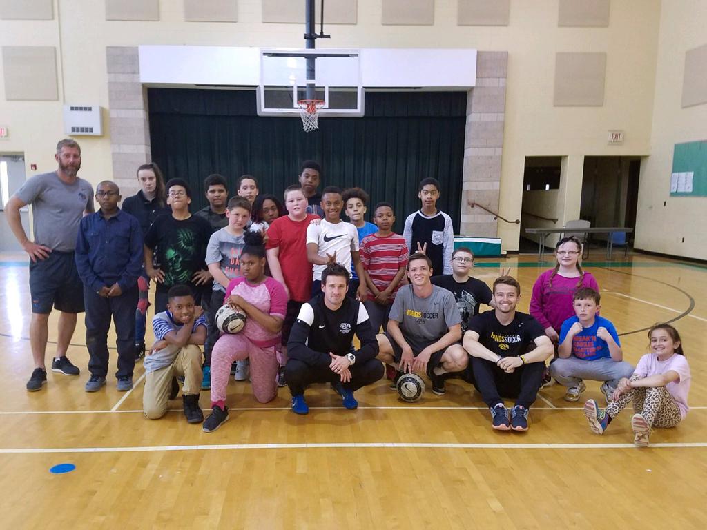 Picture of Pittsburgh Riverhounds players and staff substituting in as gym teachers at a local school district. 