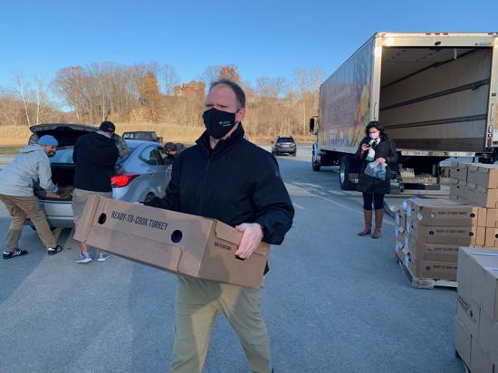 Picture of Riverhounds employee helping to deliver food for the Greater Pittsburgh Community Food Bank's Thanksgiving meal delivery. 