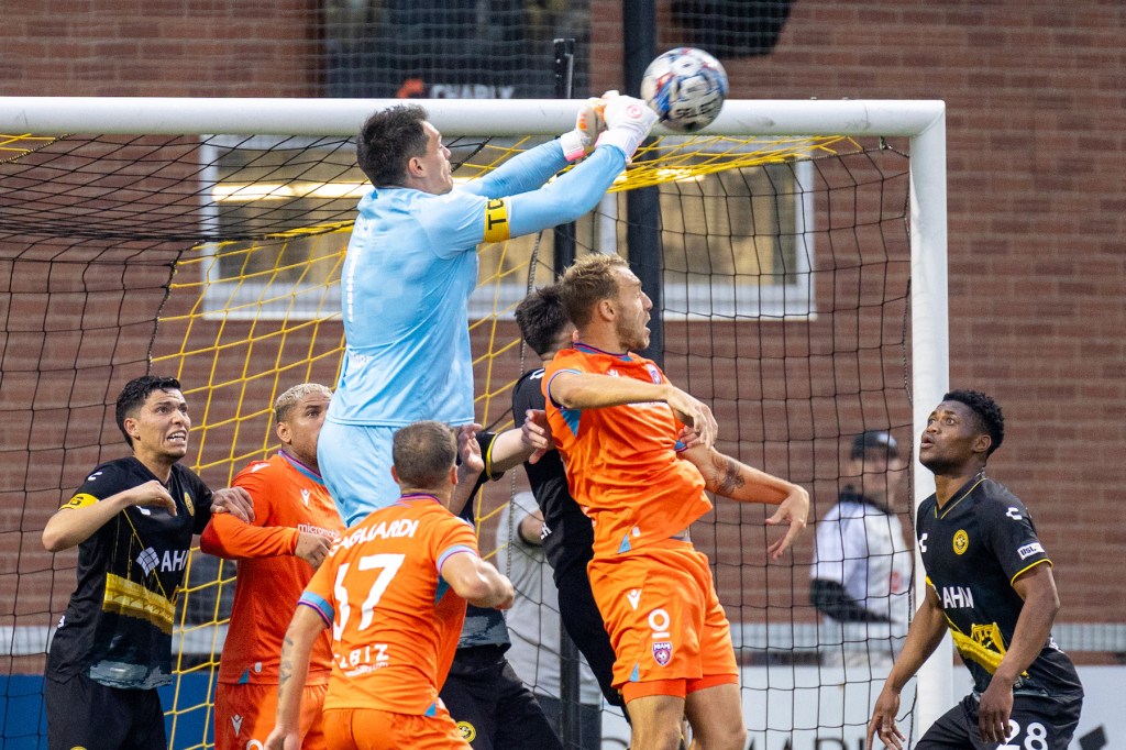 Hounds goalkeeper Eric Dick elevates to punch away a corner kick in the Hounds' 1-0 win over Miami FC last Saturday at Highmark Stadium. (Photo: Chris Cowger/Riverhounds SC)