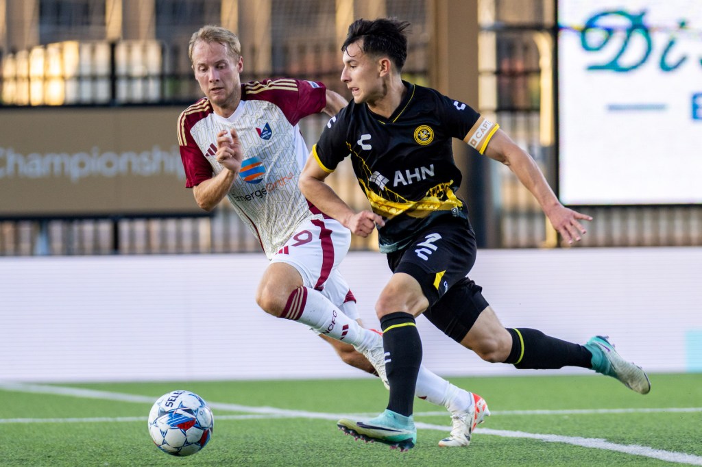Pittsburgh Riverhounds, Danny Griffin dribbles away from North Carolina's Garrett McLaughlin in a game at Highmark Stadium