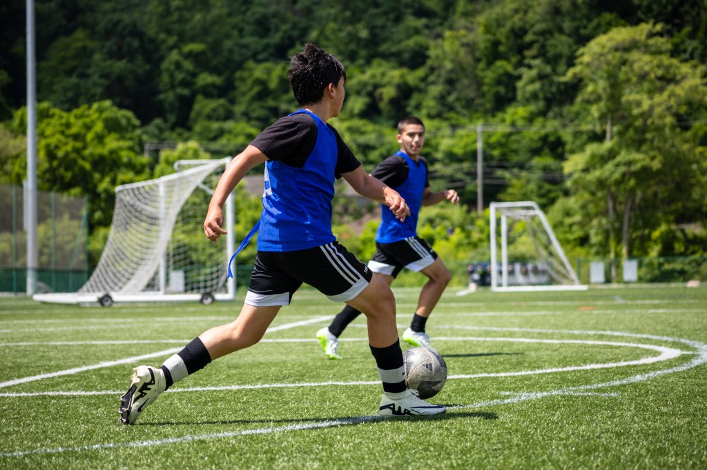 Two players from the Riverhounds Academy passing the ball during practice at AHN Montour.