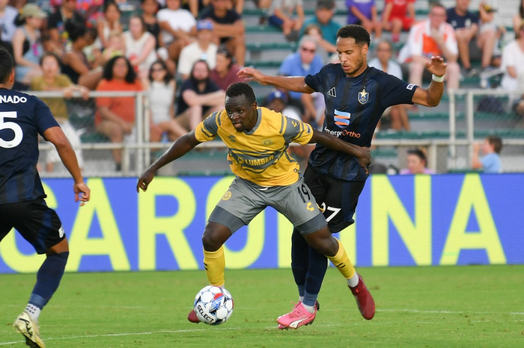 Edward Kizza shields North Carolina's Bryce Washington off the ball in the Hounds' 0-0 draw June 22, 2024, at WakeMed Soccer Park in Cary, N.C. (Photo: Zachary Taft/North Carolina FC)
