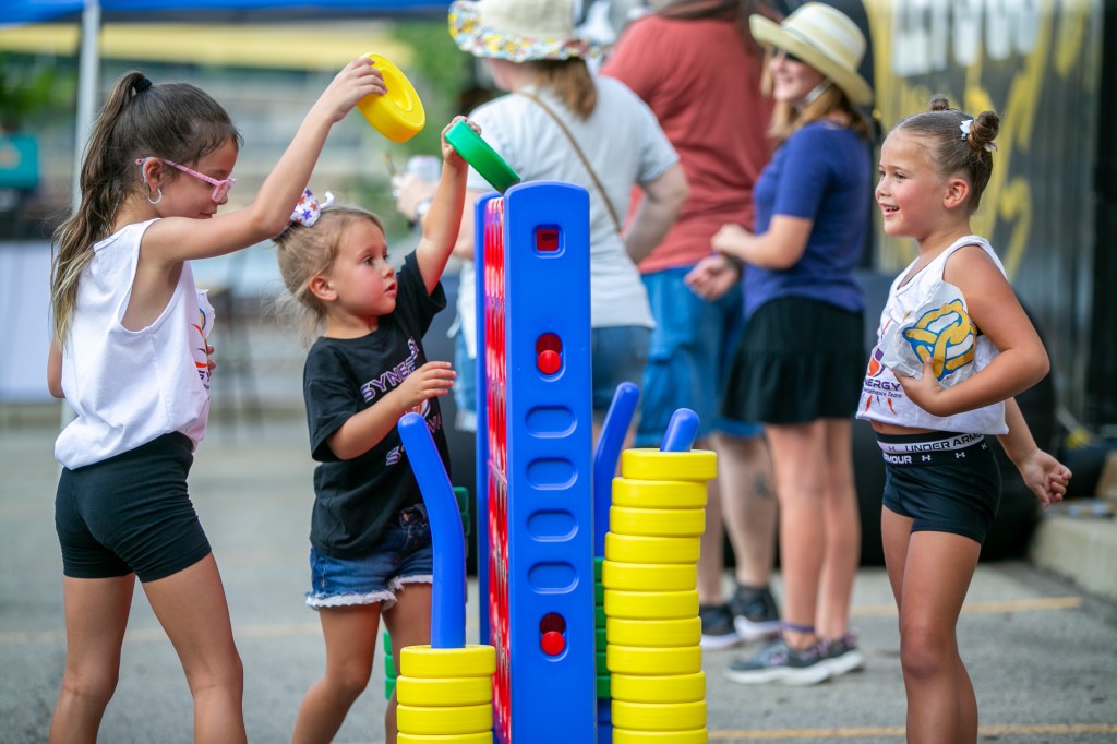 Picture of three girls playing connect4 in the tailgate zone before the pittsburgh Riverhounds home game at Highmark stadium