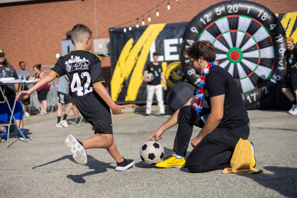 Picture of a kid playing Soccer Darts in the Tailgate Zone before a Pittsburgh Riverhounds Home game