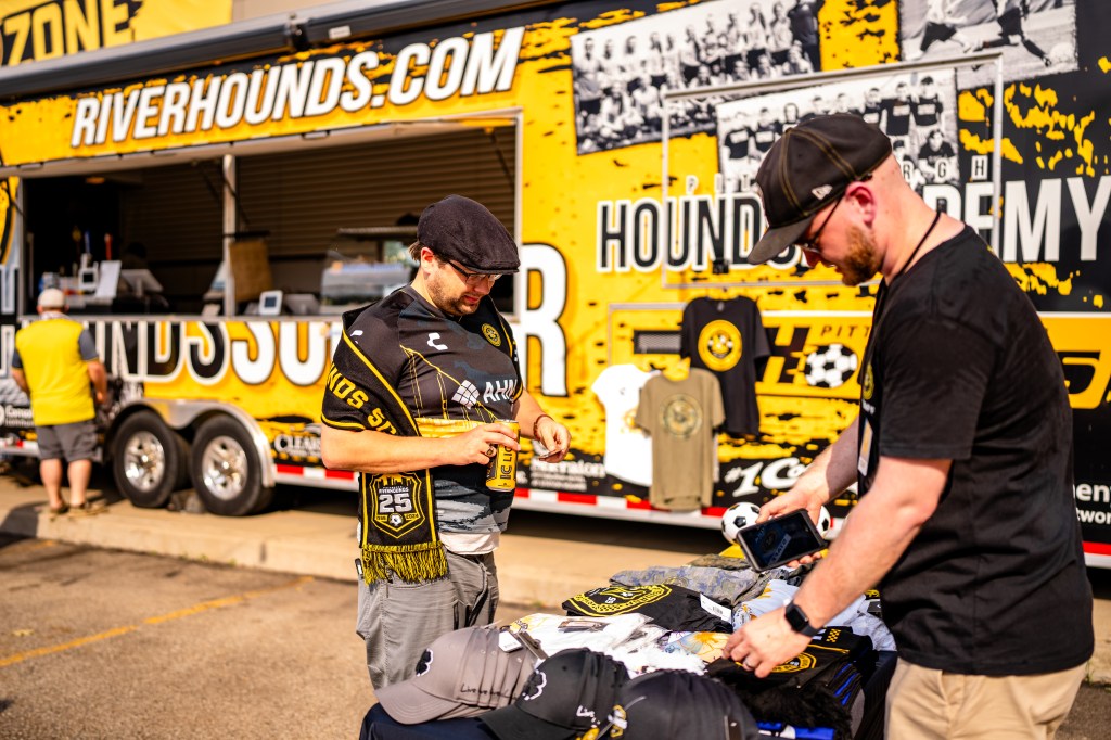 Picture of a Pittsburgh Riverhounds fan buying Merchandise in the Tailgate zone before a Hounds game