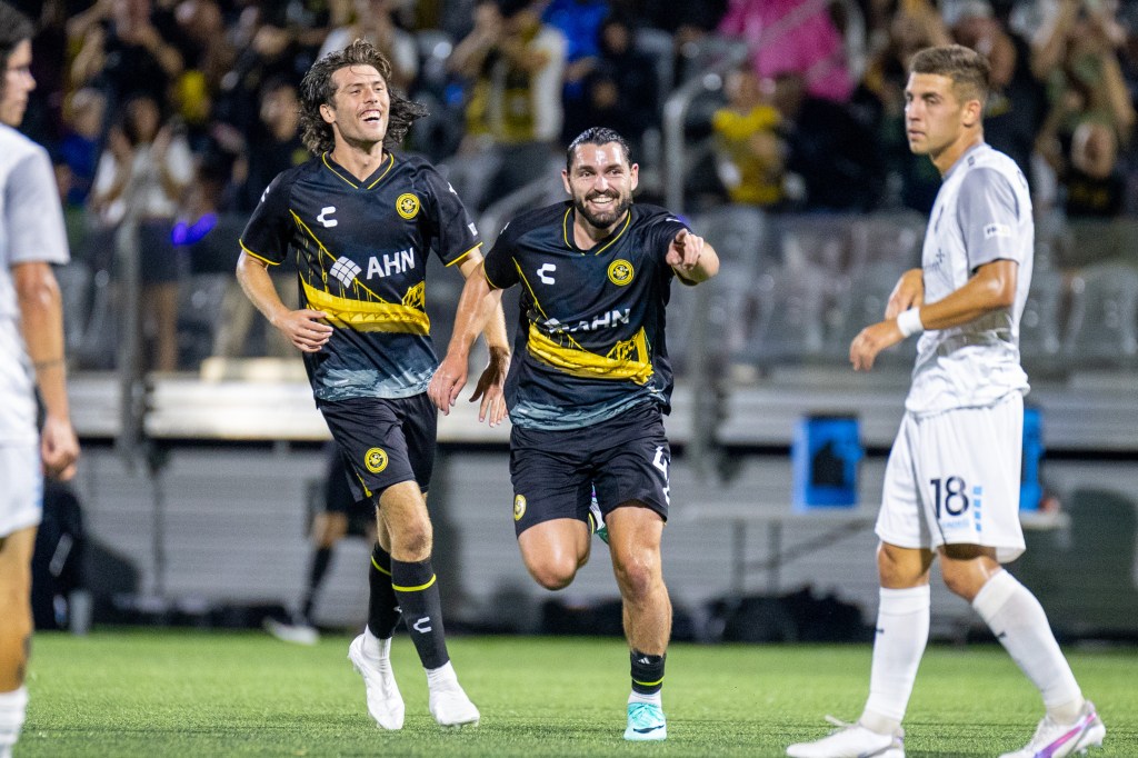 Jackson Walti is joined by Bradley Sample while celebrating his first professional goal in the Hounds' 2-2 draw with the Colorado Springs Switchbacks on Aug. 17, 2024 at Highmark Stadium. (Photo: Chris Cowger/Riverhounds SC)