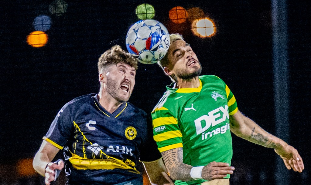 Riverhounds center back Pat Hogan and Tampa Bay Rowdies striker Manuel Arteaga contest a header during the teams' 0-0 draw on April 6, 2024 at Highmark Stadium. (Photo: Chris Cowger/Riverhounds SC)