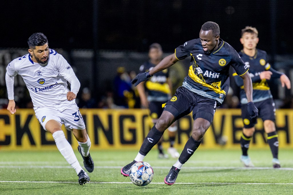 Riverhounds striker Edward Kizza dribbles away from El Paso Locomotive midfielder Robert Coronado in the Hounds' 2-0 win on Oct. 26, 2024, at Highmark Stadium.