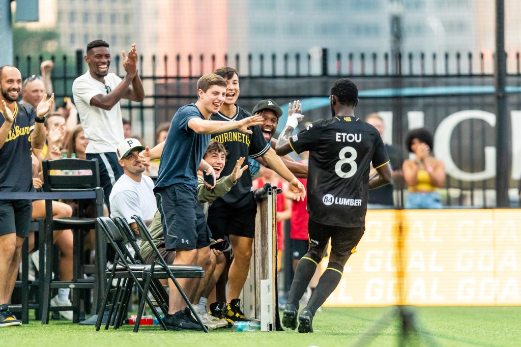 Junior Etou gets high fives from his teammates after recording the first two-goal game of his career in a 5-0 win over Oakland Roots SC on July 13, 2024, at Highmark Stadium. (Photo: Mallory Neil/Riverhounds SC)