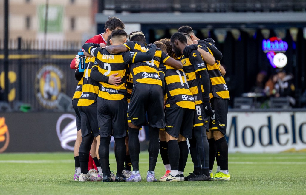 Pittsburgh Riverhounds players form a huddle prior to their 1-0 win over Hartford Athletic on March 22, 2025 at Highmark Stadium in Pittsburgh. (Photo: Chris Cowger/Riverhounds SC)
