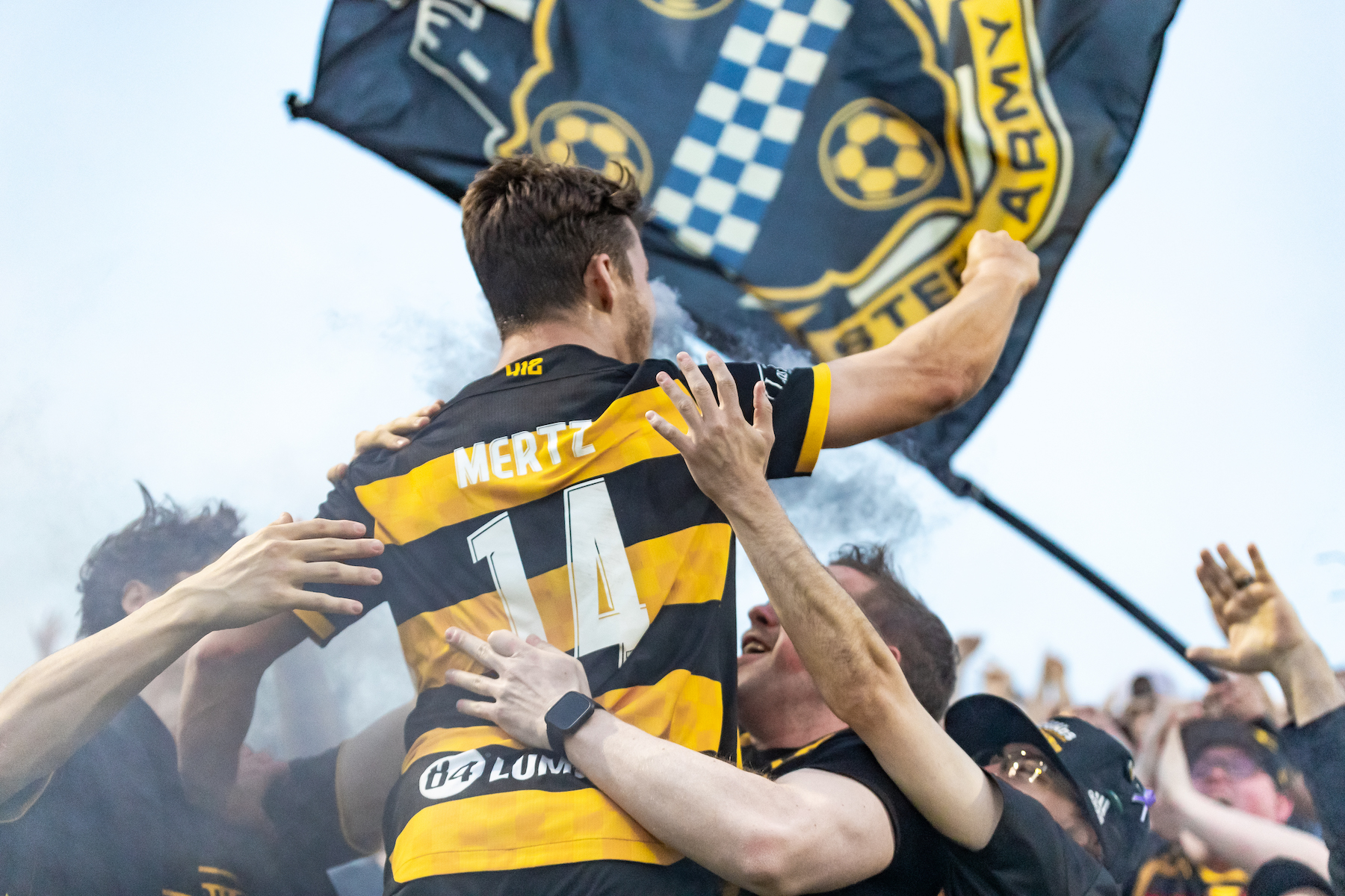 Fans celebrate with Robbie Mertz after his goal in the Riverhounds' 2-0 win over Birmingham Legion FC on March 29, 2025, which was the 100th win at Highmark Stadium. (Photo: Mallory Neil/Riverhounds SC)