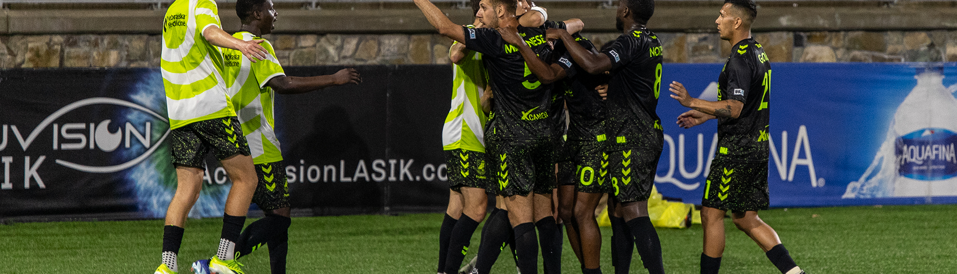 Union Omaha players celebrating a goal against Charlotte