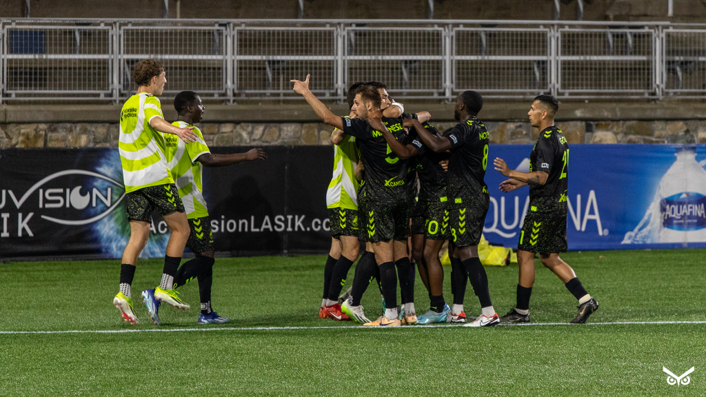 Union Omaha players celebrating a goal against Charlotte