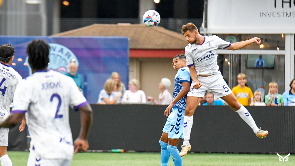 Marco Milanese heading the ball vs Madison